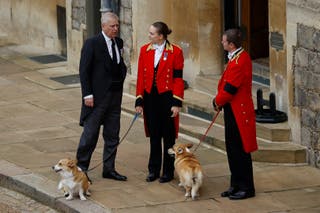 Andrew, with royal family members, holding the Queen's late corgi, Muick and Sandy, ahead of her funeral in St George's Chapel in 2022 (Peter Nicholls/PA)
